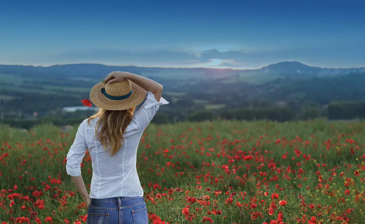 A woman in a field of flowers promotes EcoMade sustainable solutions for apparel manufactured by The LYCRA Company. 