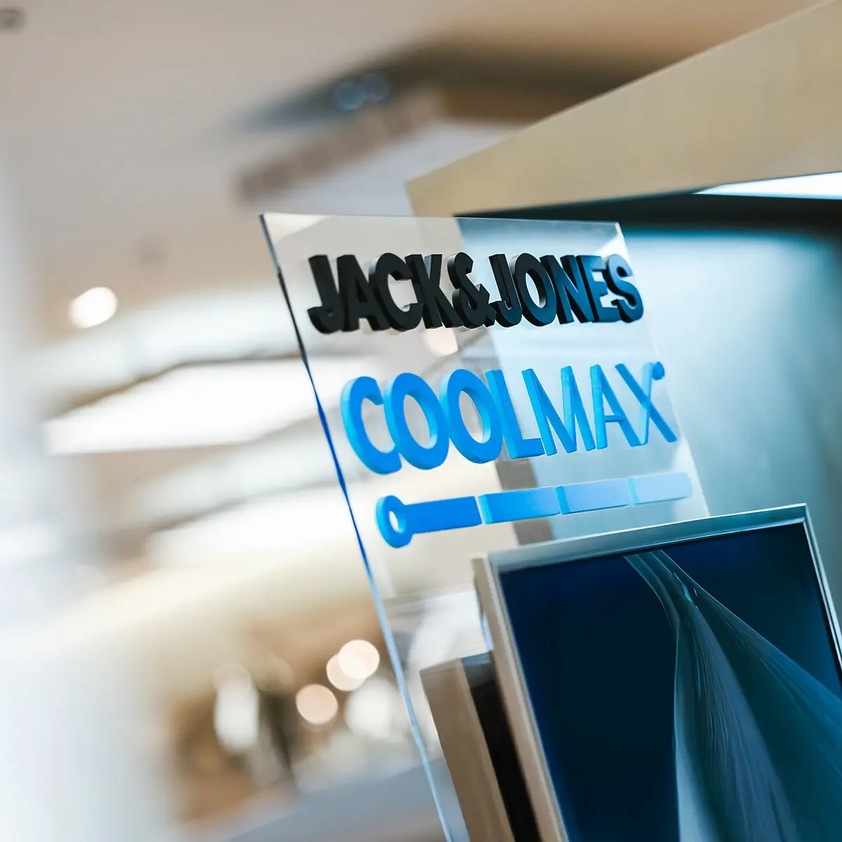 A sign showing the JACK&JONES and COOLMAX® brand logos